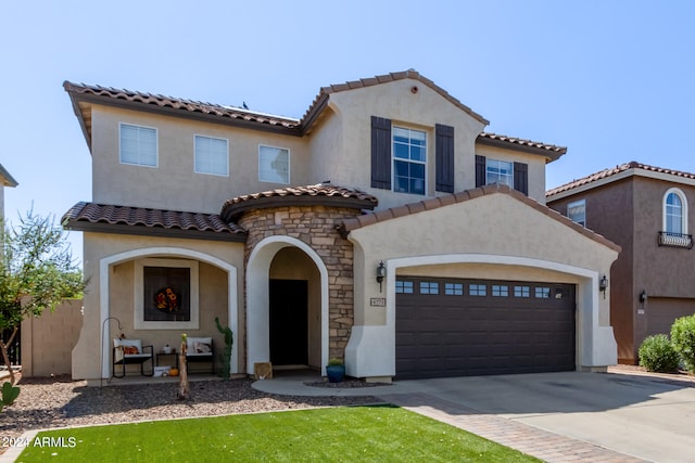 mediterranean / spanish home featuring a garage