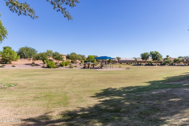 view of property's community featuring a playground and a yard