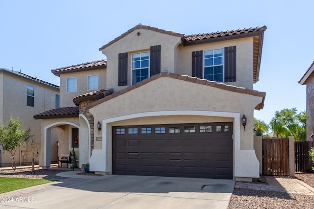 mediterranean / spanish house with a garage