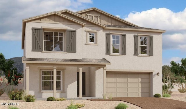 view of front of house featuring decorative driveway, an attached garage, board and batten siding, and stucco siding