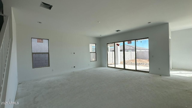 unfurnished room with visible vents