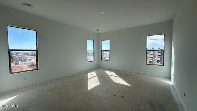 unfurnished room with visible vents