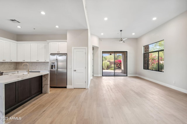 19550 N Grayhawk Dr Unit 1144, Scottsdale, AZ 85255 - kitchen featuring stainless steel fridge, light wood finished floors, white cabinetry, recessed lighting, and open floor plan