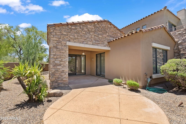 19550 N Grayhawk Dr Unit 1144, Scottsdale, AZ 85255 - view of front of property featuring stucco siding, a patio, stone siding, and a tile roof