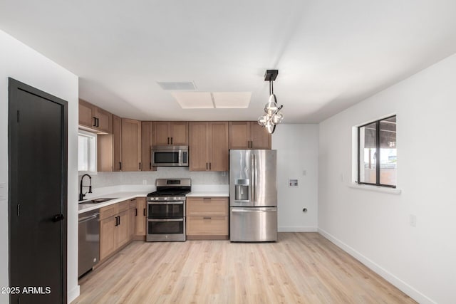 3802 N 48th Dr, Phoenix, AZ 85031 - kitchen with visible vents, a sink, light countertops, light wood-style floors, and stainless steel appliances