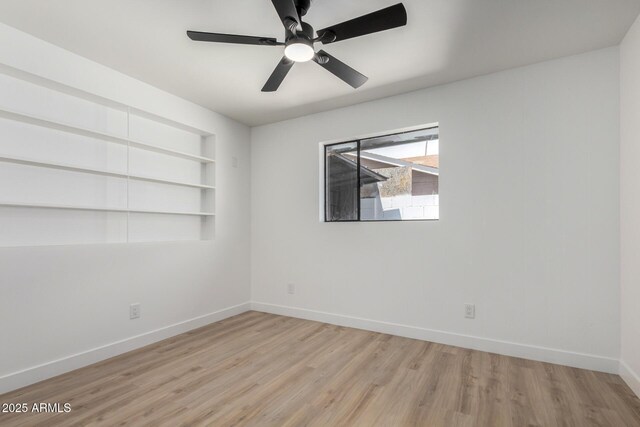 3802 N 48th Dr, Phoenix, AZ 85031 - unfurnished room with a ceiling fan, baseboards, built in features, and wood finished floors