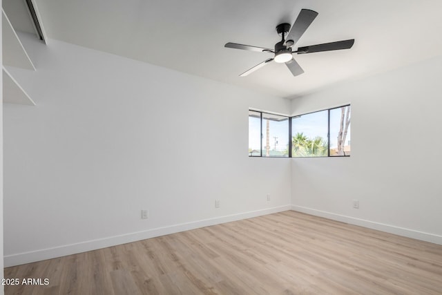 3802 N 48th Dr, Phoenix, AZ 85031 - unfurnished room with baseboards, a ceiling fan, and light wood-style flooring