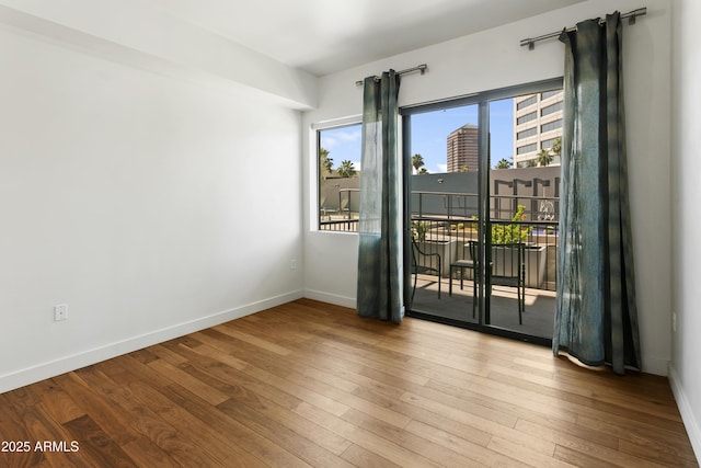 3131 N Central Ave Unit 3009, Phoenix, AZ 85012 - unfurnished room with hardwood / wood-style floors and baseboards