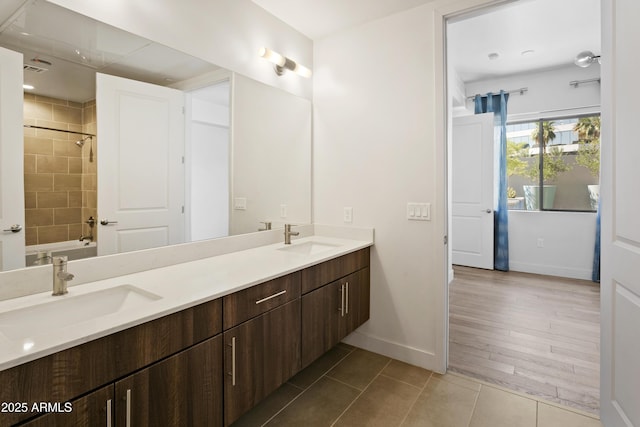3131 N Central Ave Unit 3009, Phoenix, AZ 85012 - bathroom with double vanity, baseboards, tile patterned flooring, and washtub / shower combination