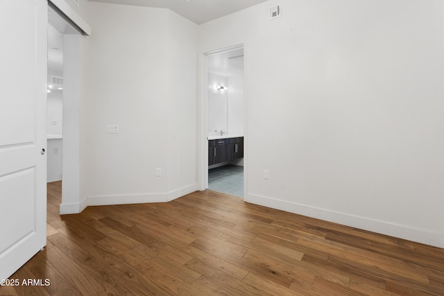 3131 N Central Ave Unit 3009, Phoenix, AZ 85012 - empty room with wood finished floors and baseboards