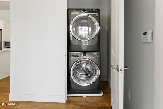 3131 N Central Ave Unit 3009, Phoenix, AZ 85012 - washroom with stacked washer / drying machine and wood finished floors