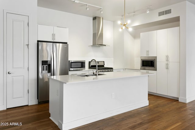 3131 N Central Ave Unit 3009, Phoenix, AZ 85012 - kitchen featuring ventilation hood, appliances with stainless steel finishes, track lighting, and dark wood-style flooring