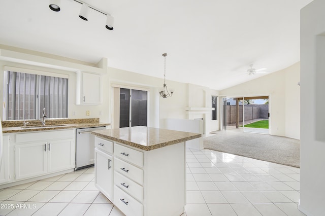 kitchen featuring vaulted ceiling, sink, dishwasher, a kitchen island, and hanging light fixtures