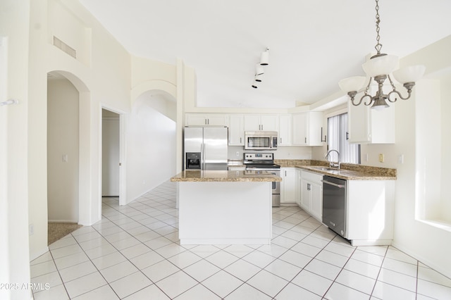 kitchen with white cabinetry, sink, a center island, hanging light fixtures, and appliances with stainless steel finishes