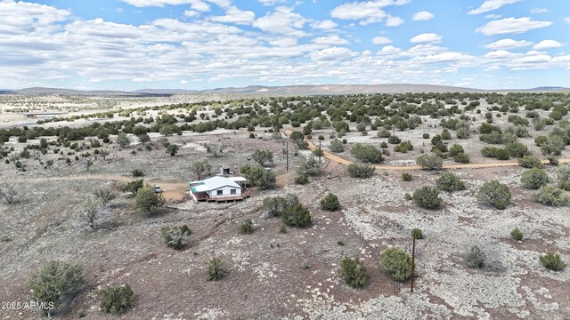 birds eye view of property with a mountain view, view of desert, and a rural view