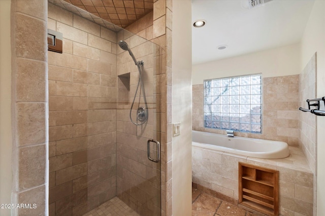 full bathroom featuring a stall shower, a bath, and recessed lighting