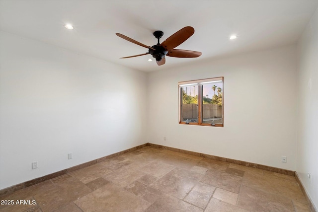spare room with ceiling fan, recessed lighting, stone tile flooring, and baseboards
