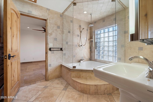 bathroom featuring a sink, tiled shower / bath, tile walls, ceiling fan, and recessed lighting