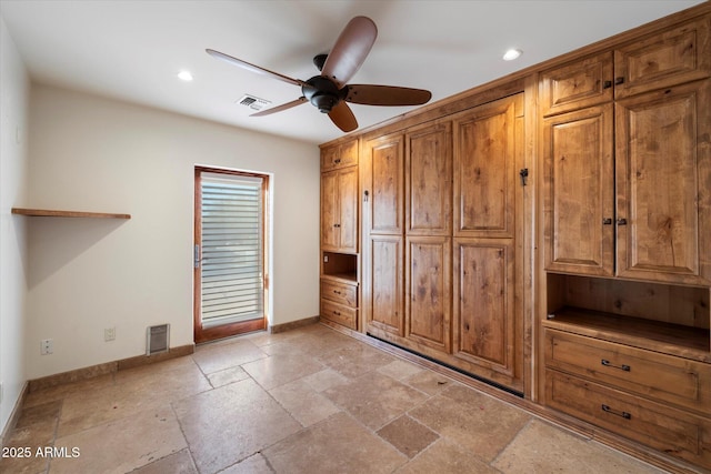 unfurnished bedroom featuring baseboards, recessed lighting, stone tile floors, and ceiling fan