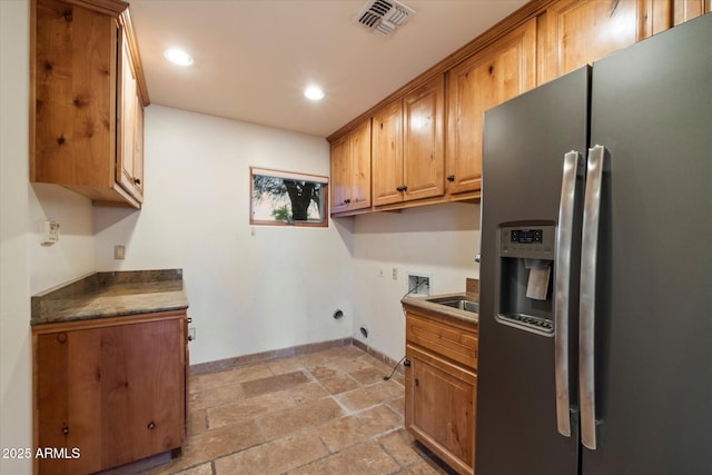 laundry area with hookup for a washing machine, stone tile floors, baseboards, cabinet space, and recessed lighting