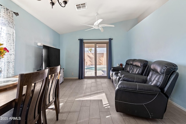 living room with ceiling fan and lofted ceiling