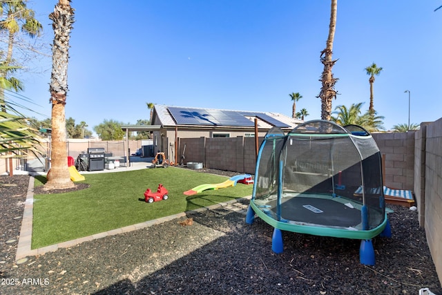 view of yard with a patio area and a trampoline