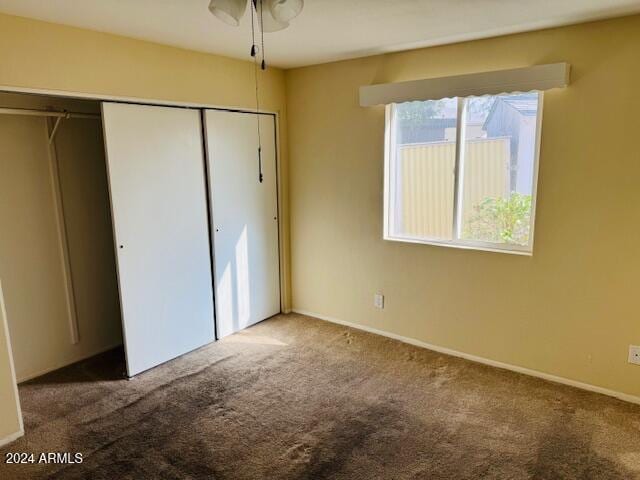 unfurnished bedroom featuring carpet floors and a closet