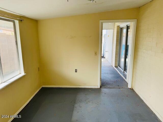 empty room with concrete flooring