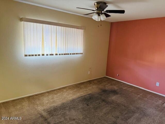 carpeted spare room with ceiling fan