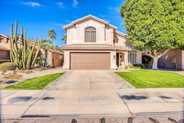 mediterranean / spanish-style house with a garage and a front yard