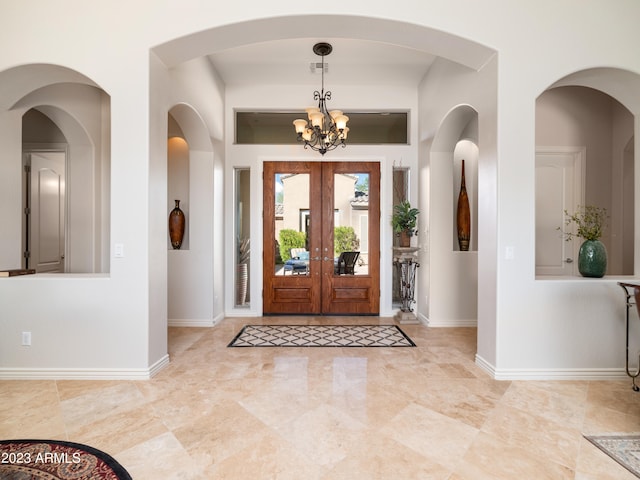 foyer with baseboards and an inviting chandelier