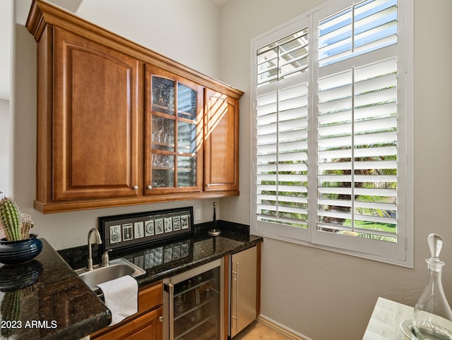 bar with beverage cooler, a sink, and bar area