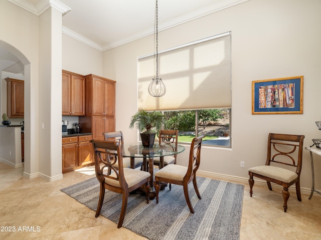 dining area with arched walkways, crown molding, a towering ceiling, and baseboards