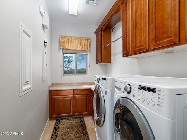 washroom featuring light tile patterned floors, cabinet space, visible vents, separate washer and dryer, and baseboards