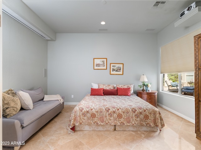 bedroom with light tile patterned floors, visible vents, and baseboards