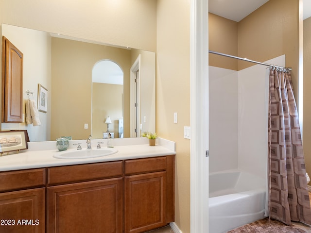 bathroom featuring vanity and shower / bathtub combination with curtain