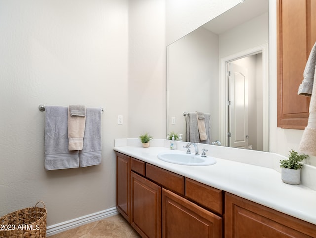 bathroom with baseboards, vanity, and tile patterned floors