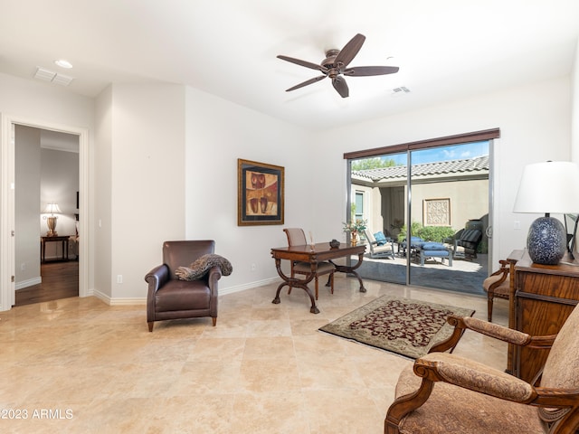 sitting room with light tile patterned floors, a ceiling fan, visible vents, and baseboards