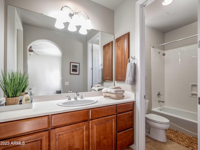 full bath featuring shower / bathtub combination, toilet, a ceiling fan, vanity, and tile patterned floors