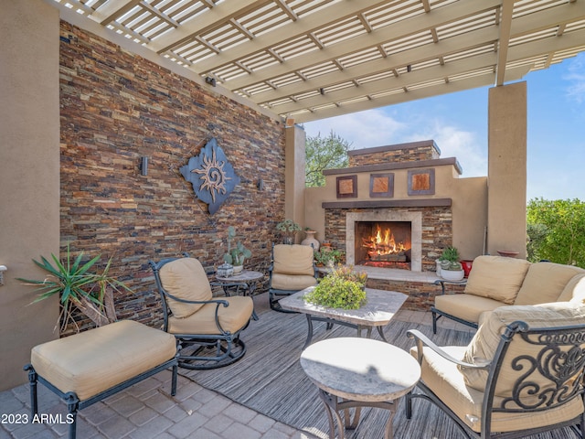 view of patio featuring an outdoor living space with a fireplace and a pergola