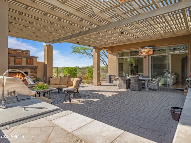 view of patio with outdoor dining space, fence, an outdoor living space with a fireplace, and a pergola