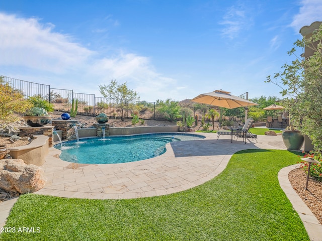 view of swimming pool with a yard, a patio area, fence, and a fenced in pool