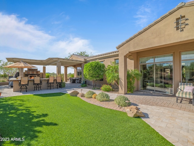 view of yard featuring outdoor dry bar and a patio