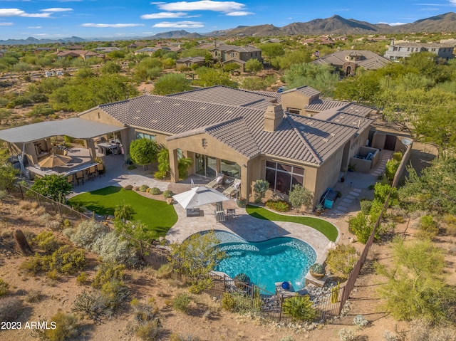 birds eye view of property with a mountain view