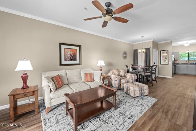 1941 S Pierpont Dr Unit 2015, Mesa, AZ 85206 - living room with wood finished floors, baseboards, a ceiling fan, crown molding, and a chandelier