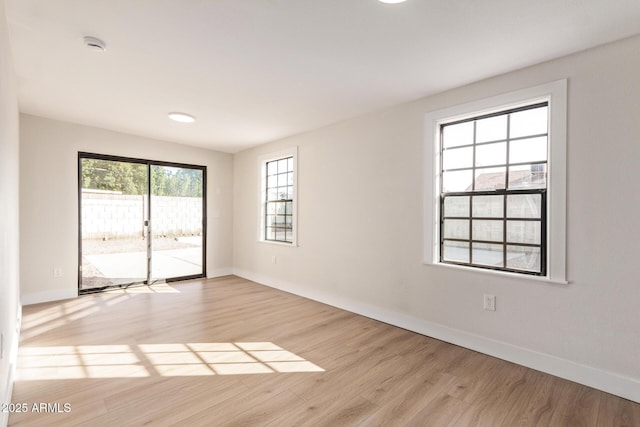 unfurnished room with light hardwood / wood-style floors