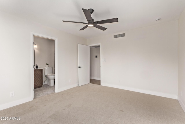 unfurnished bedroom with carpet, ceiling fan, and connected bathroom