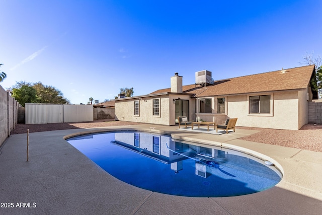 view of pool with a patio and central AC