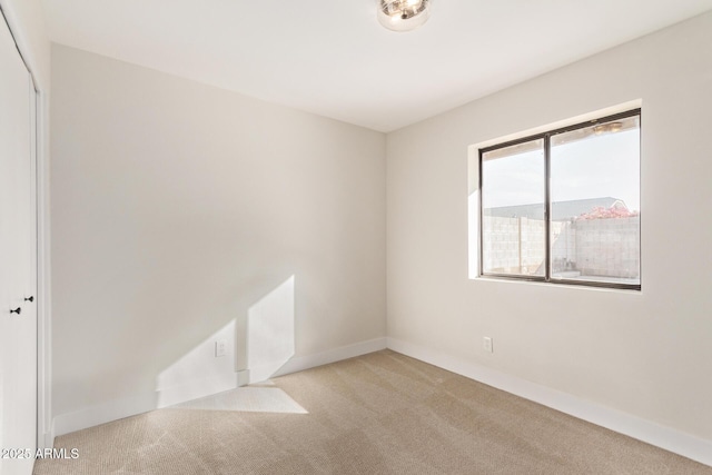 empty room featuring light carpet