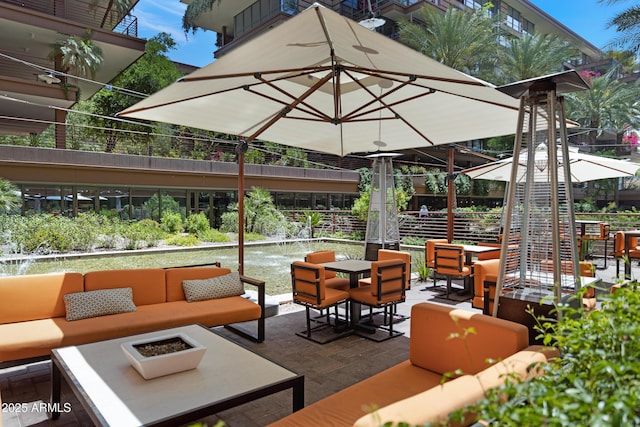 view of patio featuring an outdoor living space with a fire pit